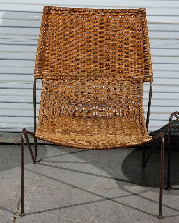 Pair of Frederick Weinberg wicker lounge chairs with black painted iron legs