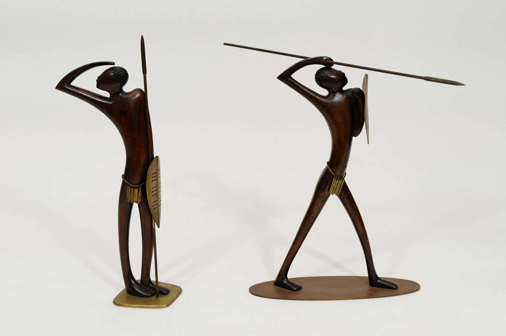 Pair of large, highly stylized wood and bronze Hagenauer African Warriors. Each is signed: Hagenauer Wien, wHw, Made in Austria.  Both warriors are 11 inches high.
