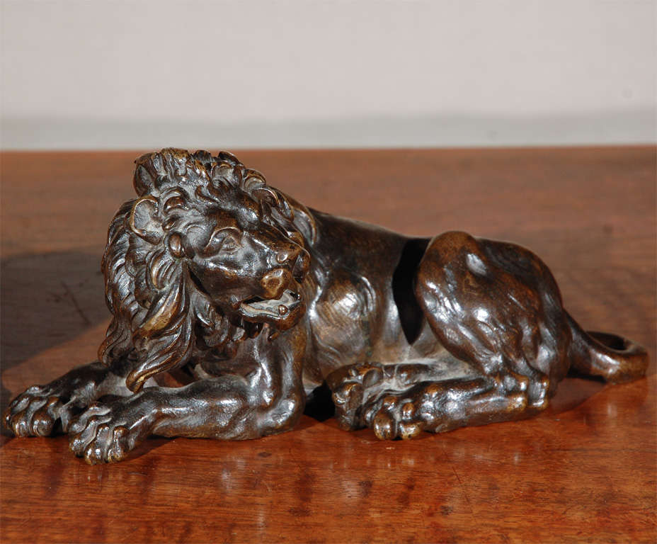 Fabulous pair of detailed, hand-cast, recumbent, left and right bronze lions with lush, flowing manes.