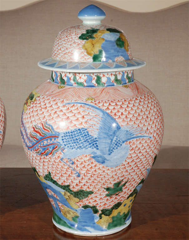 Vibrant pair of fish scale patterned, ginger jars with lids.