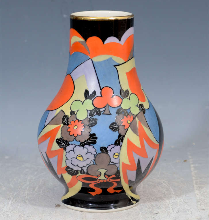 A vintage art deco Japanese vase with two female figures in brightly colored robes and flowers on a black background. The piece is signed Kikozan.