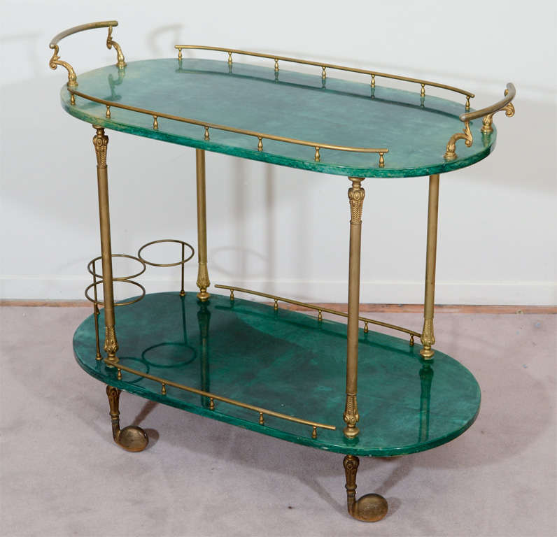 A vintage tea or bar cart with two shelves in emerald green lacquered goatskin and brass detailing. The piece is by Aldo Tura.

Reduced from: $3,750