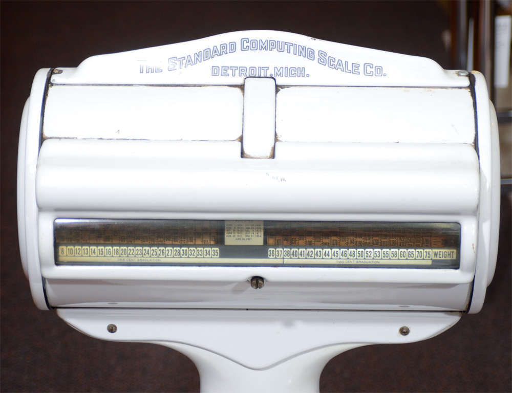 An antique commercial scale in white enameled metal by the Standard Computing and Scale Company of Detroit, Michigan.