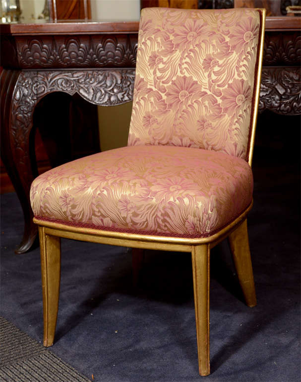 A set of ten side chairs from the luxury ocean liner SS Normandie, considered one of the premier ocean liners of all time. The chairs were originally used in the ships Grand Salon. Each has a gilt wood frame and floral silk upholstery.