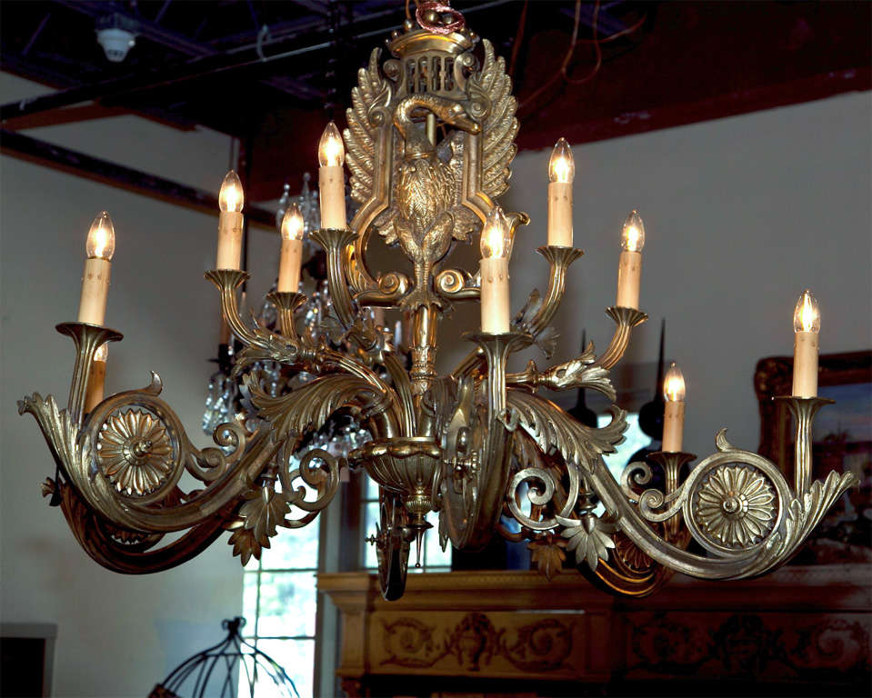 A stunningly beautiful Russian antique solid bronze chandelier.  This 19th century piece has been totally cleaned, polished and rewired. A double sided swan shield adorns both sides of the chandelier. It has two tiers with 6 arms on both levels for