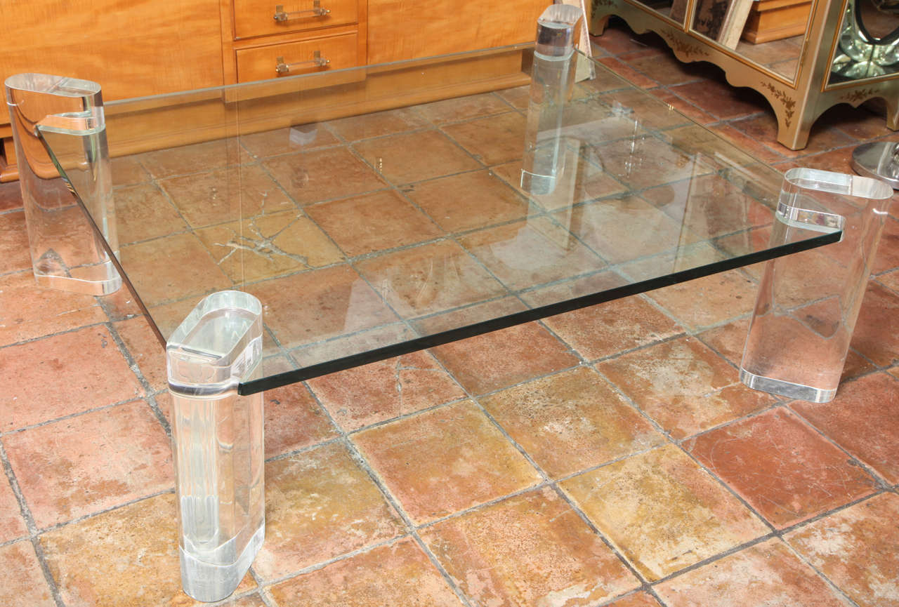 A great large glass coffee table with thick lucite corner legs from 1980s
The glass can be modified to a smaller dimension if desired as it is fitted 
into the lucite legs.