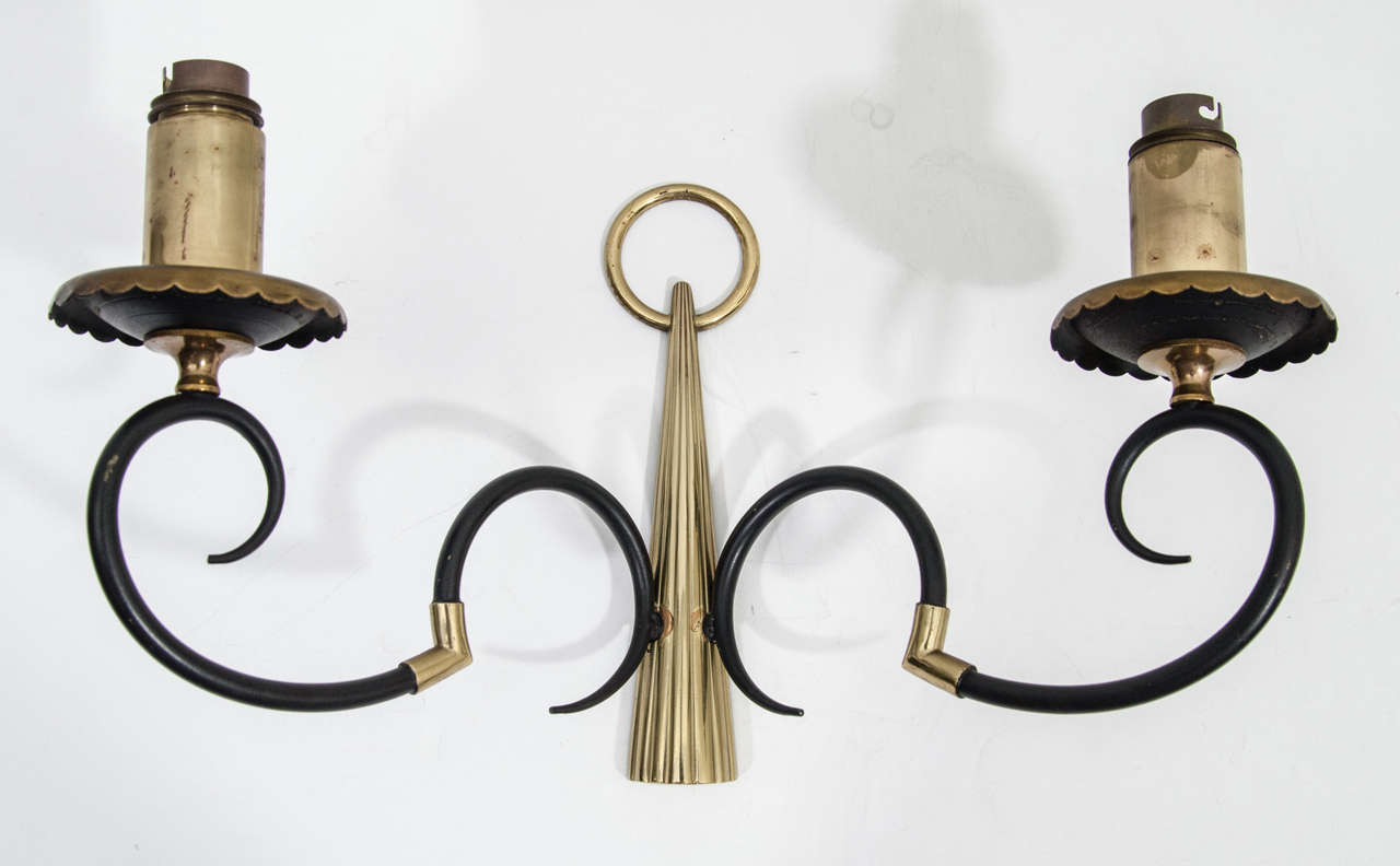 A vintage set of four brass and enamel two light sconces by Arlus. European sockets and wiring.
second set of four sconces available at storage in France