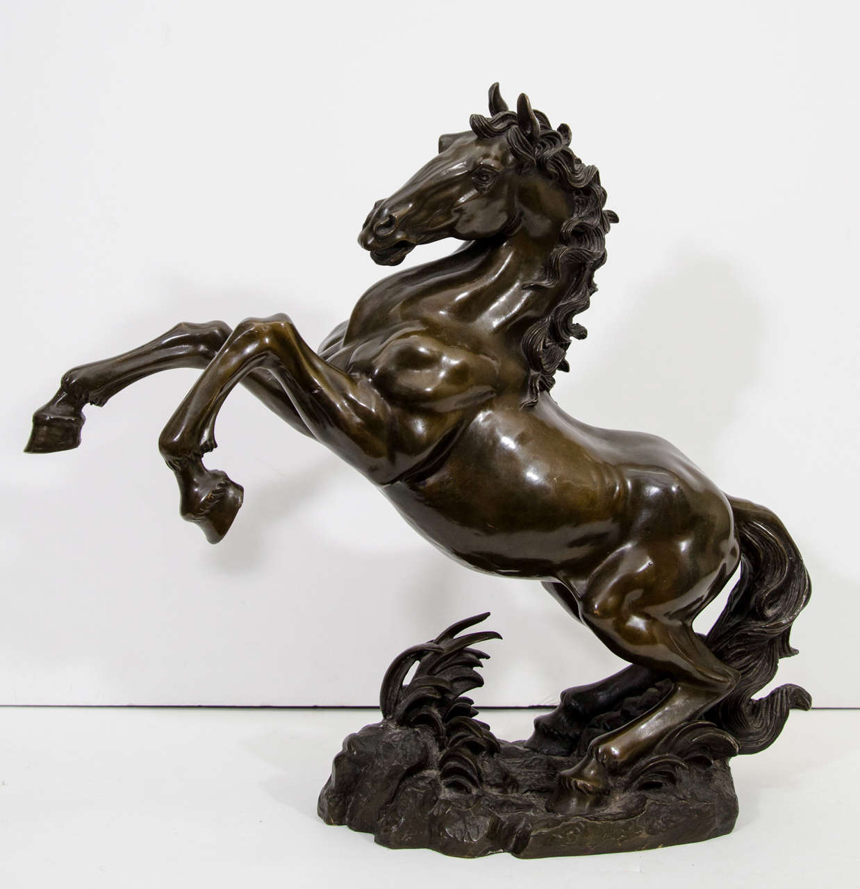An antique Japanese bronze sculpture of a horse. The piece dates from the Meiji Period.