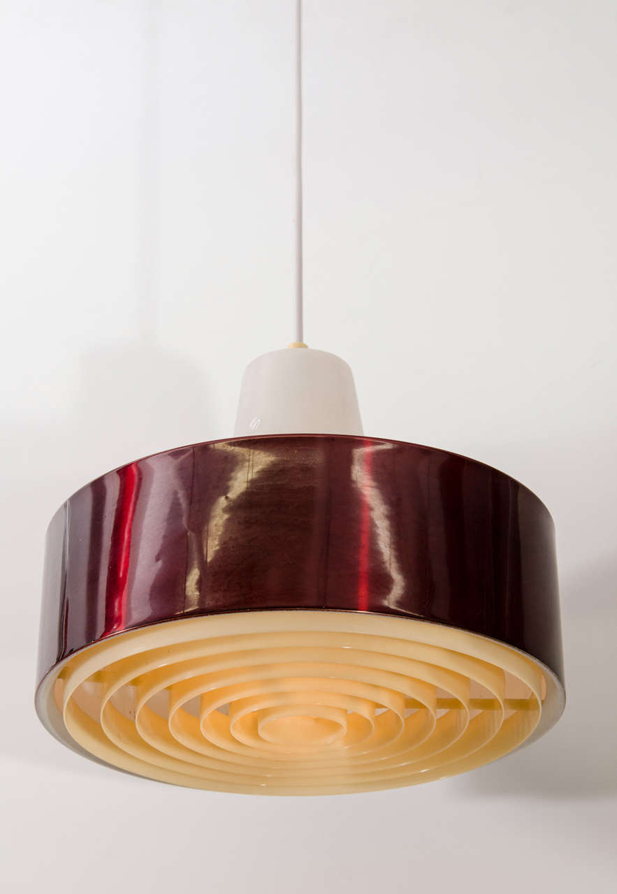 A vintage mid-century pendant light with a metallic red drum-form body.

Reduced from: $1,400