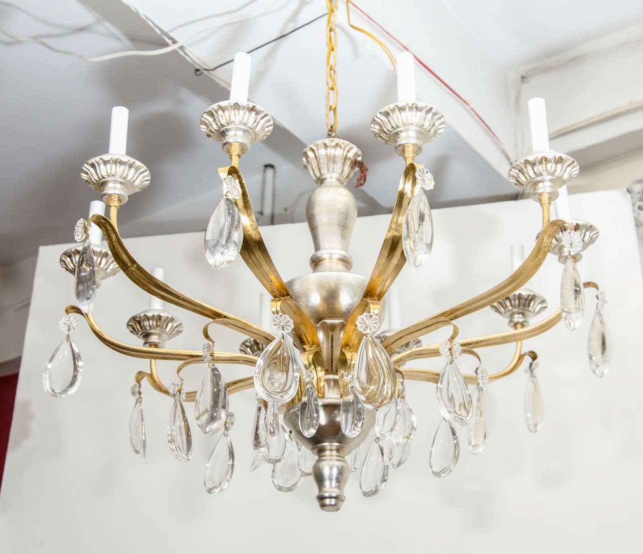 A vintage 10-light chandelier in silvered and gilt wood with suspended crystals