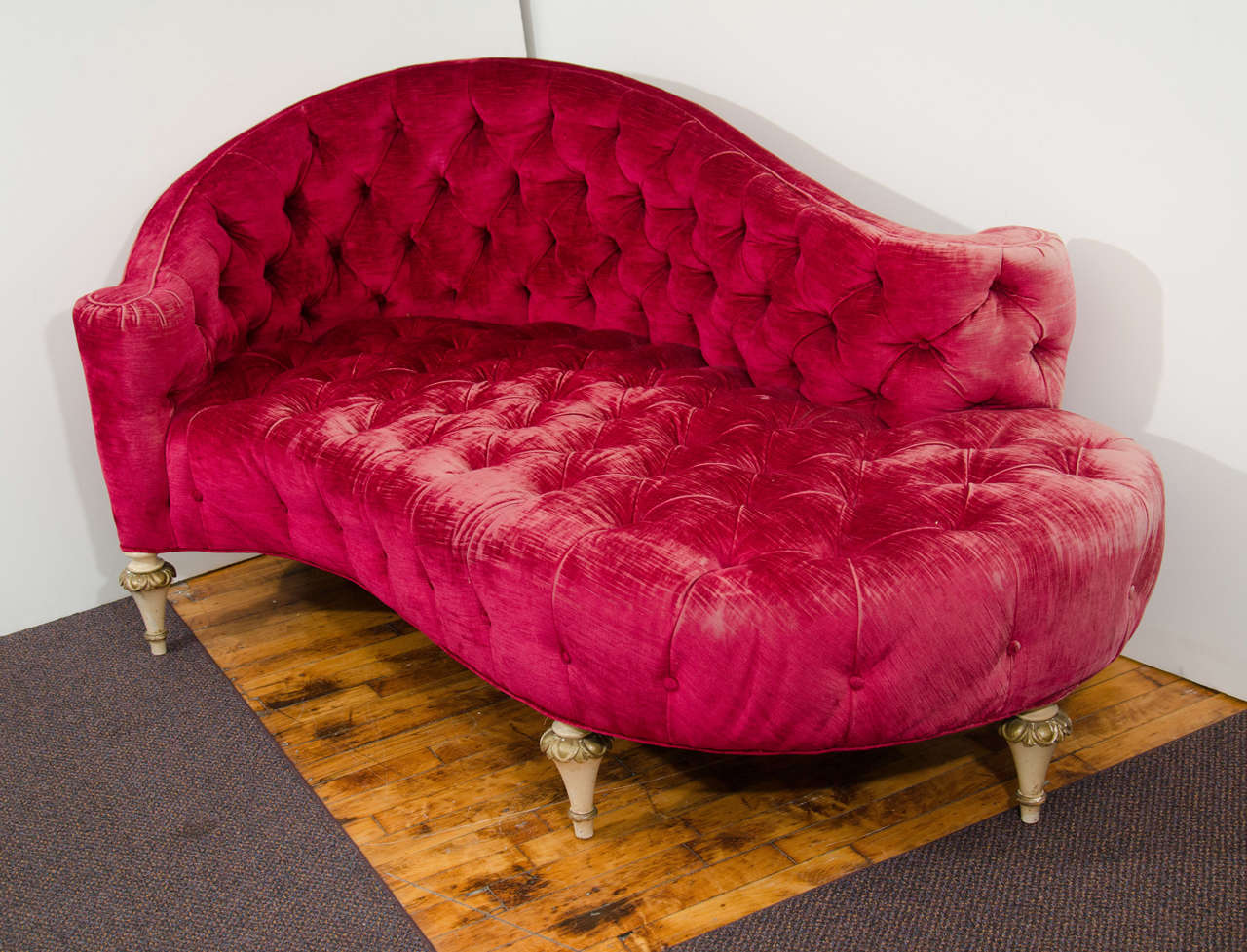 A vintage magenta button-tufted chaise recamier-form lounge chair with gilt wood feet. Original vintage condition with age appropriate wear; distressed fabric and some missing buttons