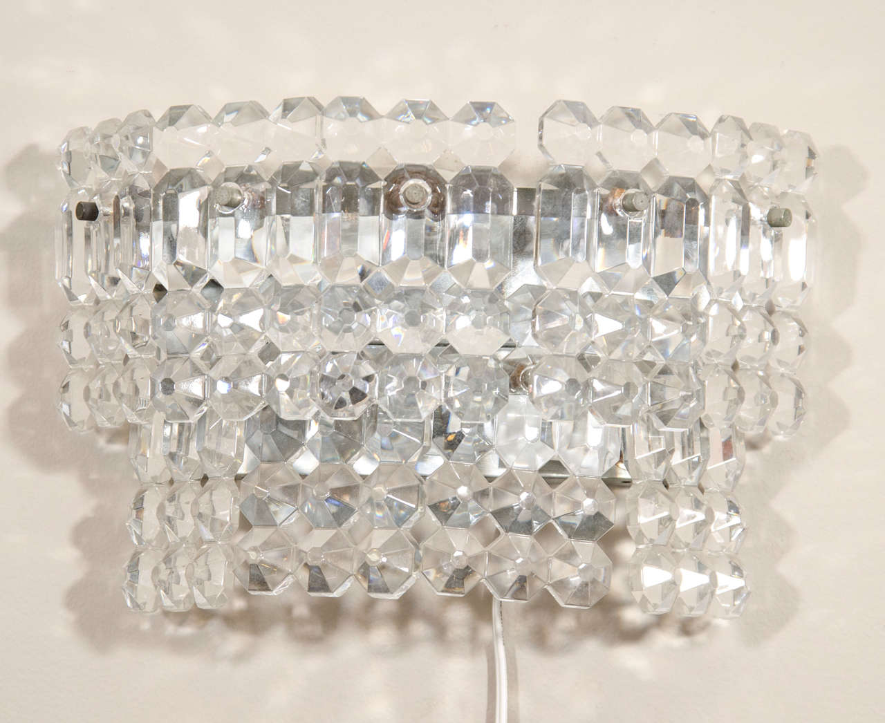 A vintage pair of Italian clear faceted glass wall-mounted lights.

Reduced from: $3,600.