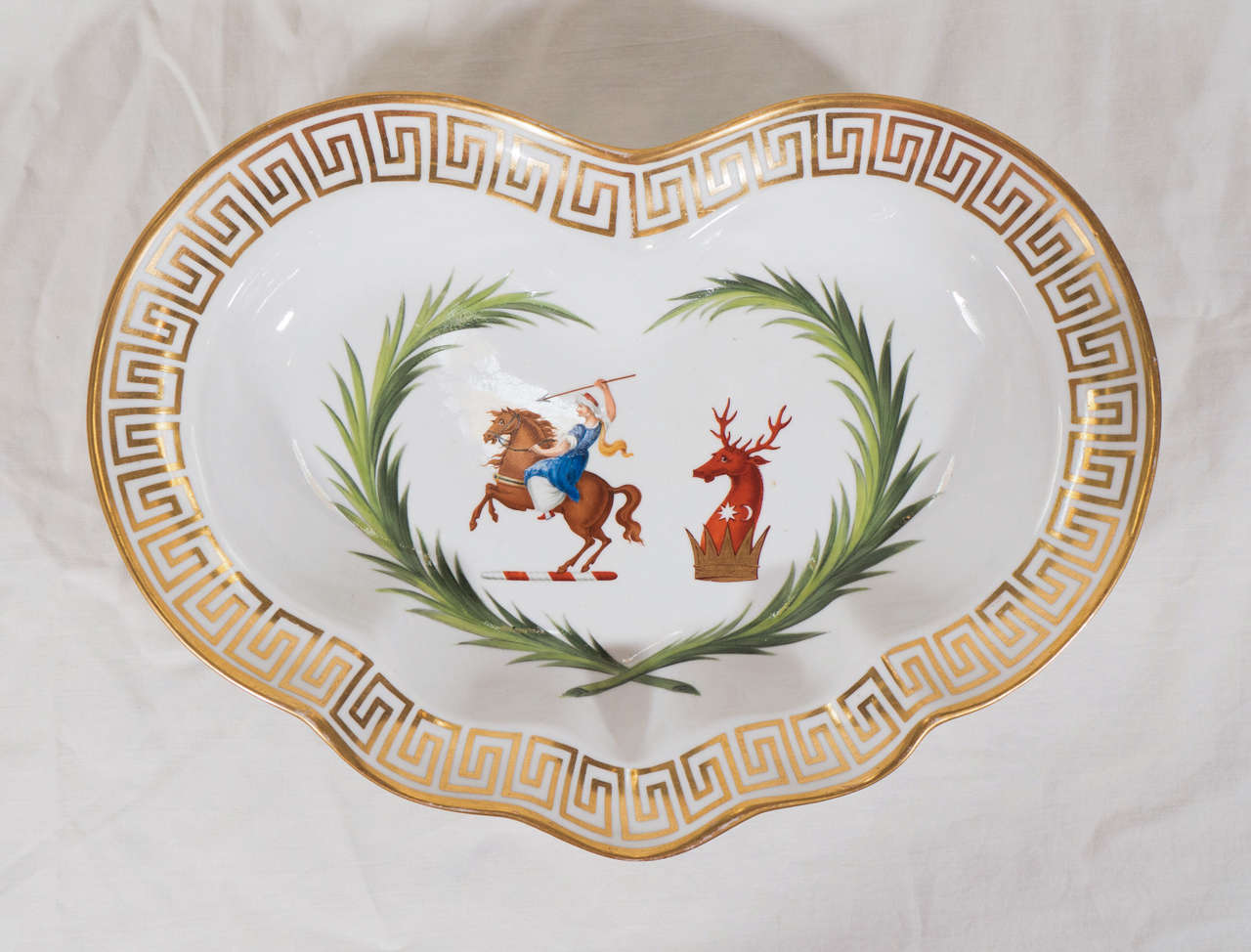 A pair of Chamberlain's Worcester heart-shaped dishes with a bold design showing the large double crest of General Sir John Doyle, Baronet of the Island of Guernsey framed within a victor's laurel wreath. The armorial is beautifully bordered with a