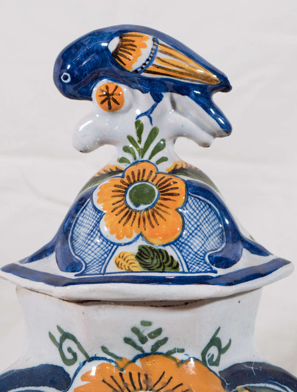 An18th century garniture of five Dutch Delft vases: three covered and a pair of trumpet vases made in the factory of the 