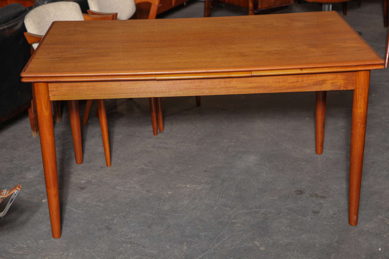 Vintage 1960s Teak Dining Table from Denmark

This Vintage Dining Table is in like-new condition, and can fit up to 10 people. When this table is closed you can comfortably fit 4 or max it out with 6. The 2 leaves nest under the table on each side