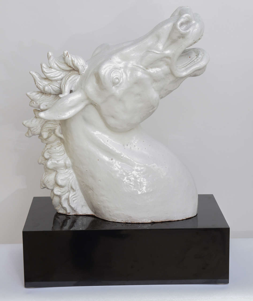 Life size Sculpture of a Terracotta White Glazed Horse Head on Black Lacquer stand.
Great condition, no chips or repairs.
