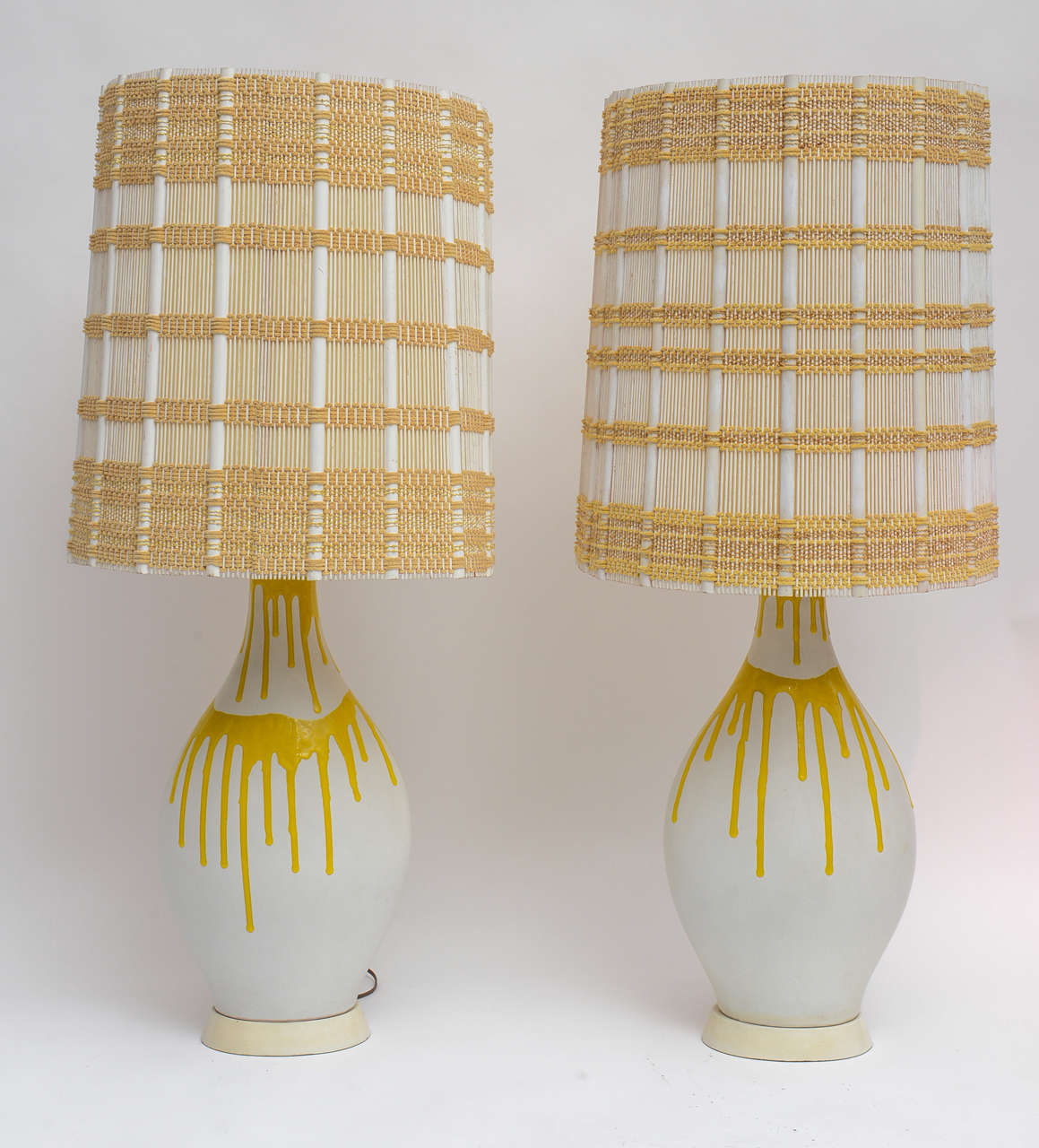 Chic pair of 1950s white ceramic lamps with dripping yellow glaze. (Shades not included)