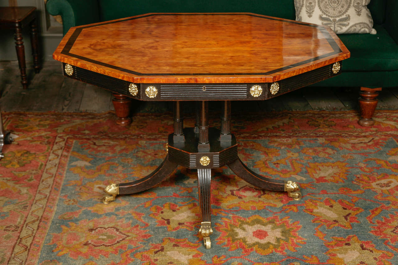 West-Indian satinwood with ebony border. On an ebonized mahogany base with original gilt brass patera and casters with a revolving top. With four Oak lined drawers to the apron with original brass locks. Signed on the drawer with the pen, J. Hansen,