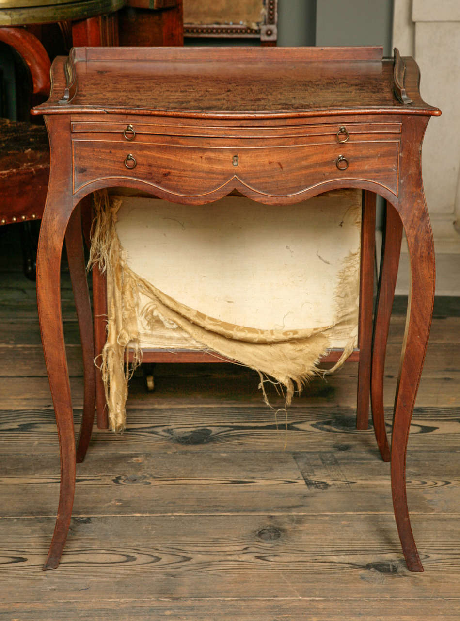 Attributable to John Cobb with rising screen and concealed drawer on shaped slender cabriole legs. English, circa 1770.