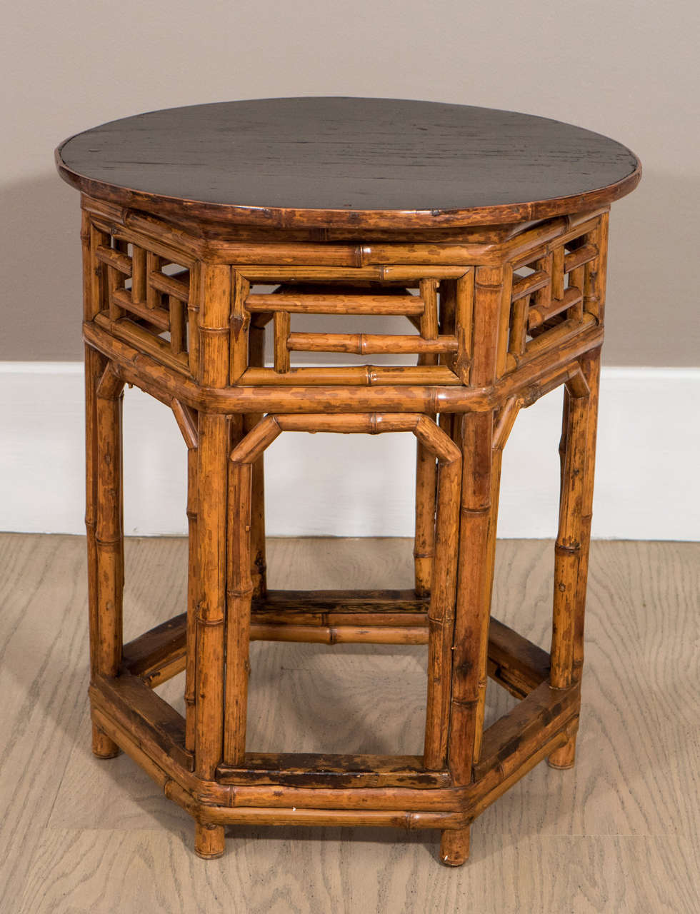 Pair of bamboo low tables with ebonised tops with bamboo edge, supported by hexagonal bases. Late 19th or early 20th century.