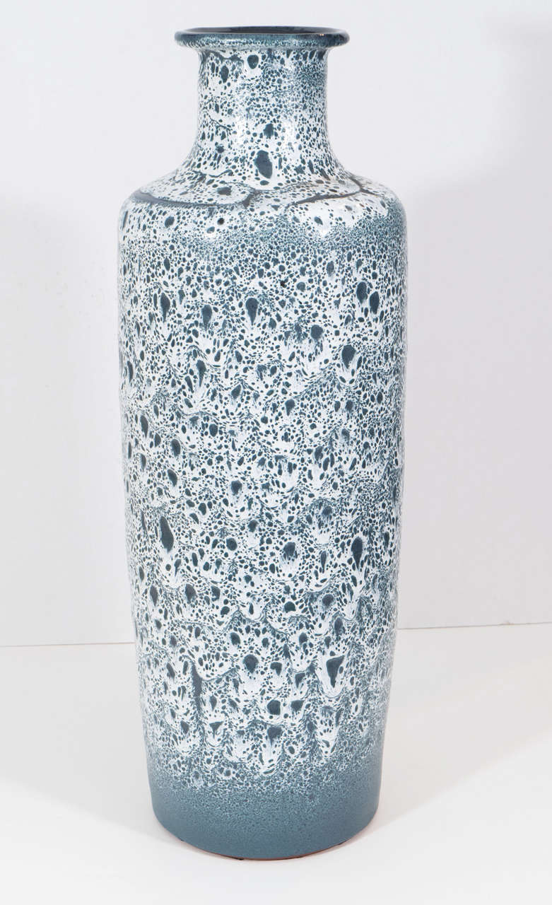 Turquoise glazed terracotta vase with heavy white stippled overlay.