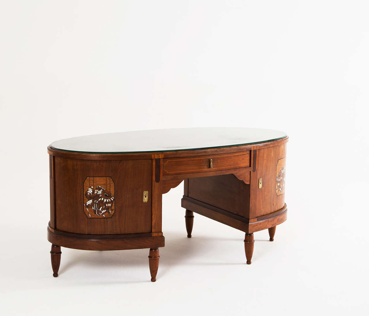 Desk, in mahogany, nacre and brass, France 1930s. 

Very sophisticated mahogany Art Deco executive desk. The front and back are identical, both equipped with a drawer and two curved doors. Each door has a beautifully made veneer and