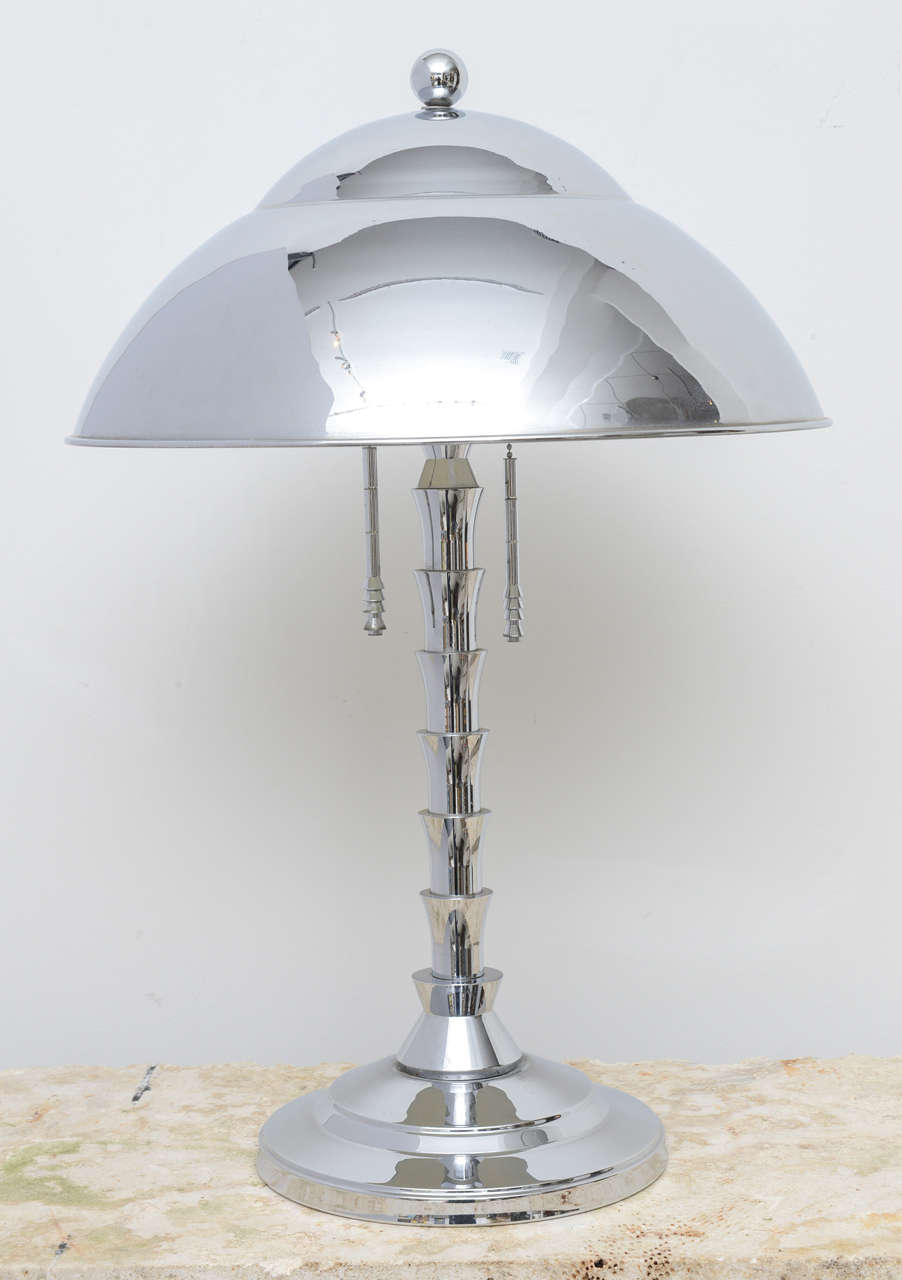 Art Deco style chrome lamp by designer Jay Spectre. A well designed lamp to the last detail even the pull chains repeat the skyscraper motif.
Base measures 10