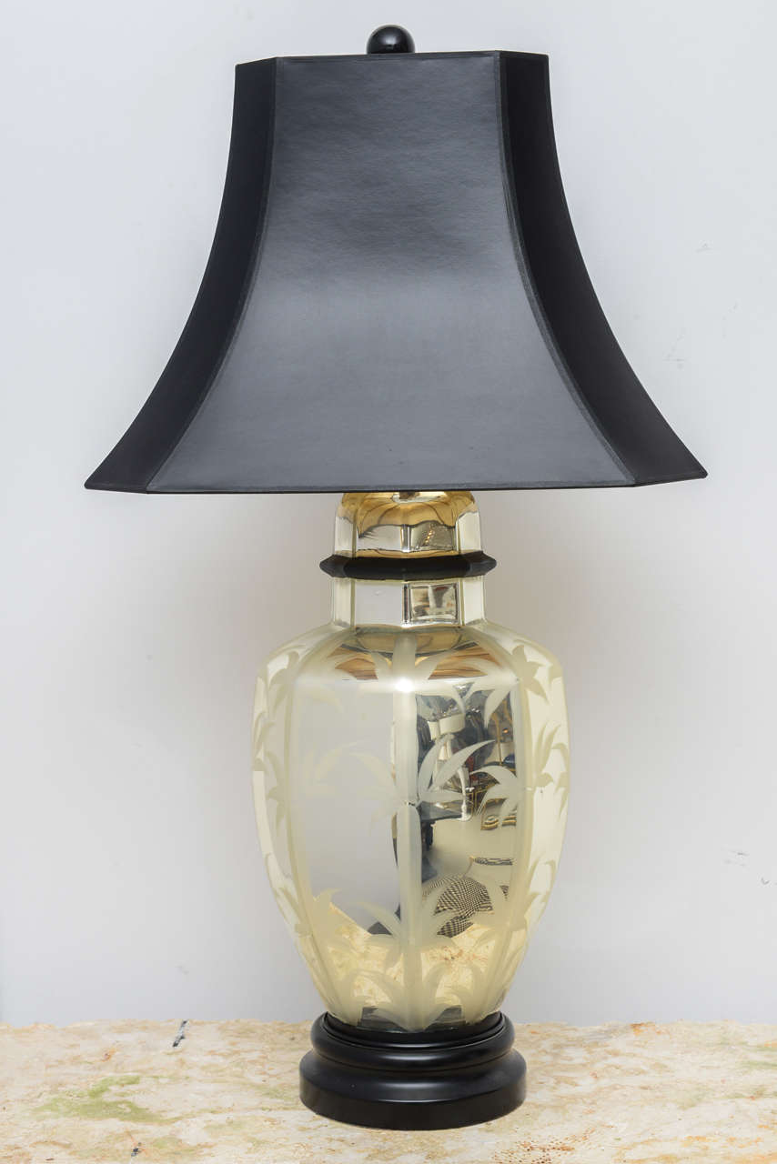 Single ginger jar shaped mercury glass lamp with bamboo motif and black wooden base. Includes shade.