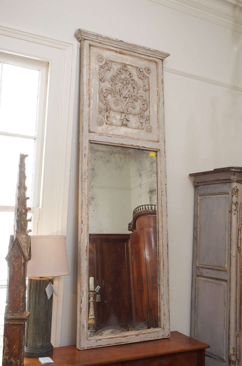19th century Italian trumeau mirror in grey/cream/blue colors with intricate flower motif.