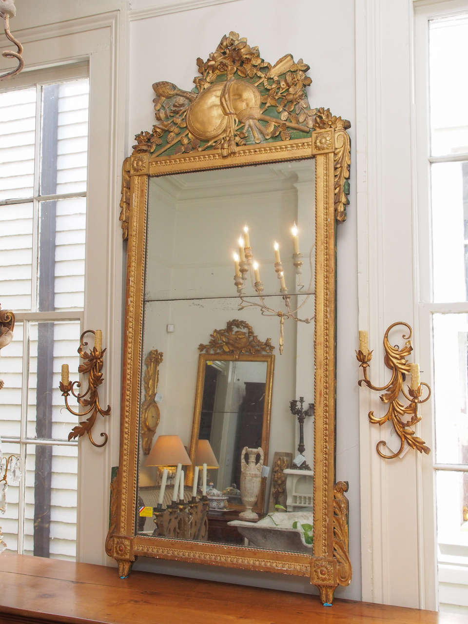 Beautiful 18th century carved gilded wood trumeau with a two parts mirror and a green painted background on top.
