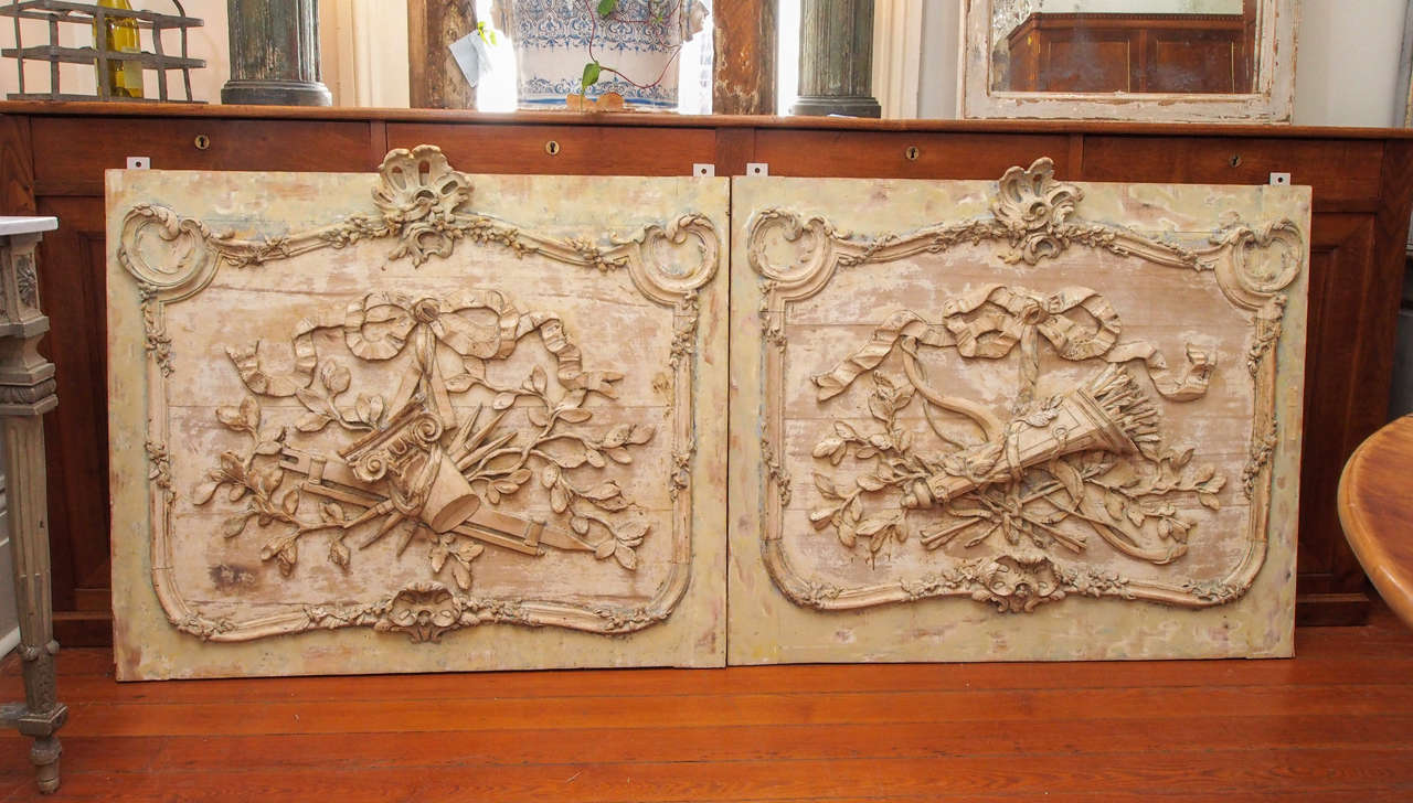 Pair of early 19th century architectural panels with the traditional carved neoclassical relief .The central carving in  each panel is different