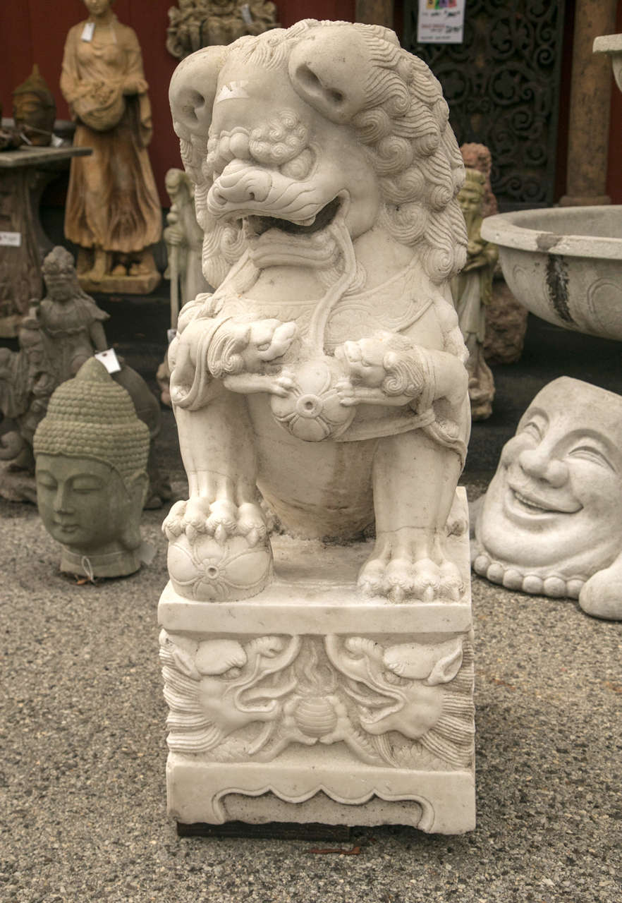 Vintage glimmering shimmer solid white marble sculpture of a pair of marble Foo dogs. Also called guardian temple lions this size statuary is stately with finely detailed handcrafted carvings. Notice the playful detail on the statues. Foo dogs are