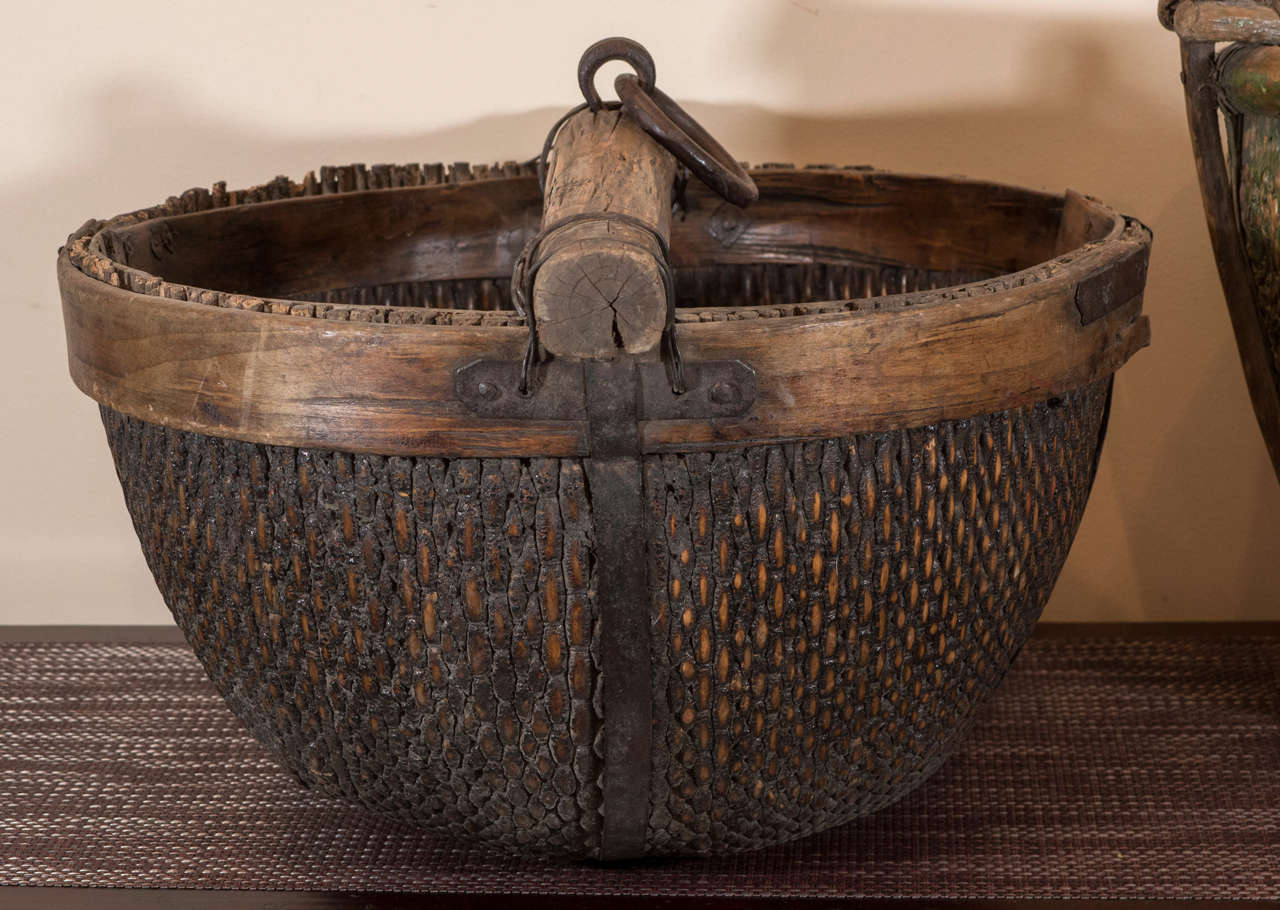 Antique Chinese willow water baskets with original cast iron hardware and sturdy wooden handle. With rounded bottoms. From Shanxi province, circa 1900.
Priced individually. Only the green piece is still available. 
B440.