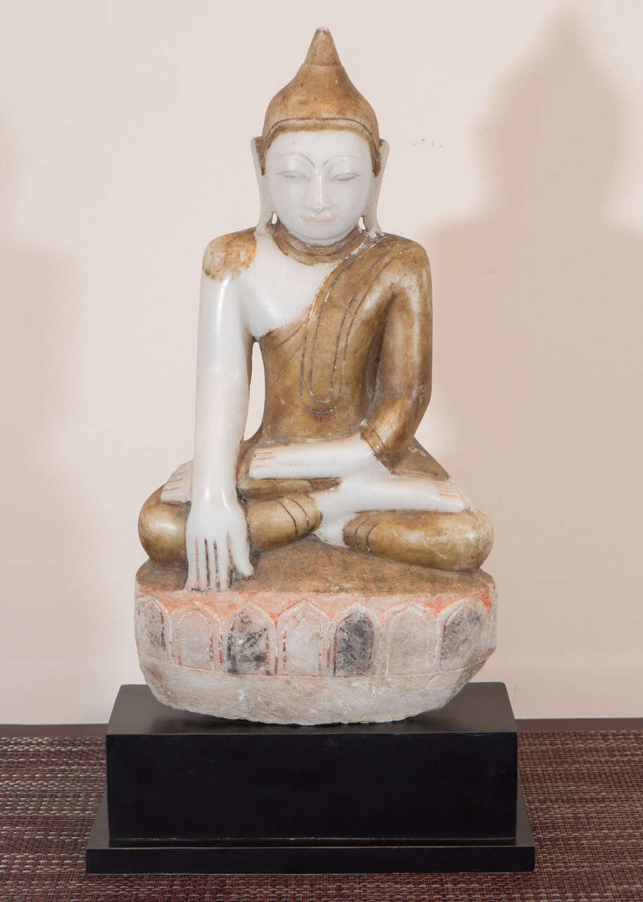 A soothing Burmese, Shan style, alabaster Buddha with gold robe and soft faded colors on stone base. Bhumisparsa Mudra position (calling the earth to witness). Burma, circa 1750.  Height of Buddha without base is 18