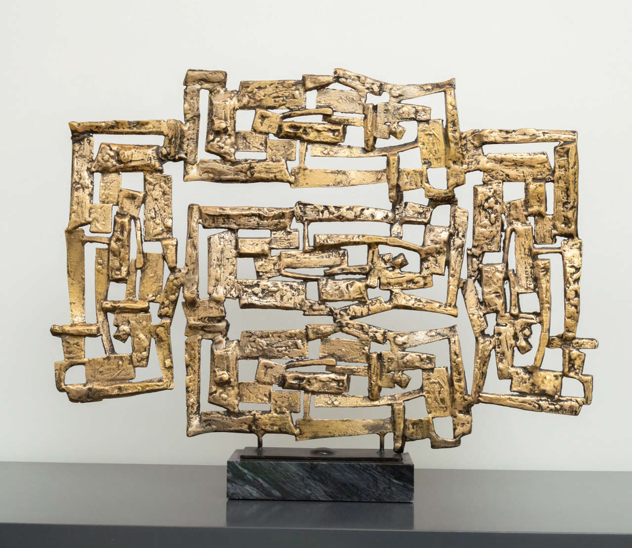 Great Brutalist sculpture in a gold tone and marble base.