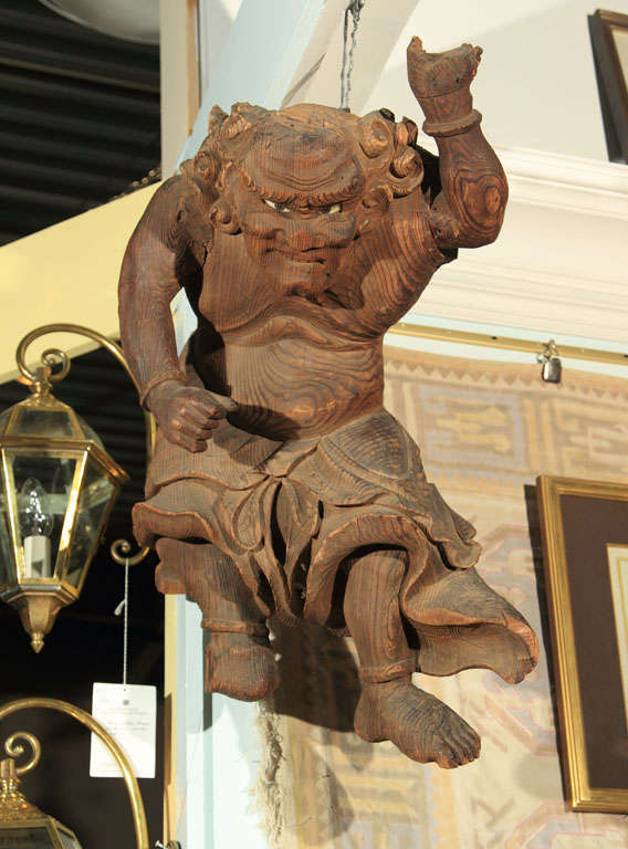 A carved Japanese carved wooden figure of the wind god, Fujin one of the eldest Shinto gods retaining its original porcelain eyes.