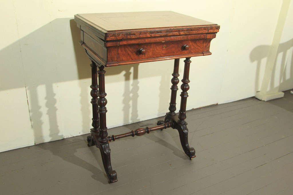 A ROSEWOOD WORK TABLE, WITH TURN AND  FLIP OPEN TOP, A SINGLE DRAWER OPENS TO REVEAL MAPLE WOOD  SEWING INSTRUMENT SECTIONS, 4 COLUMNS, SCROLL FEET