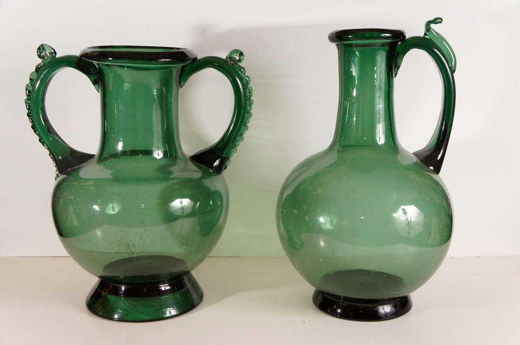 This not matching pair of large vases are blown in a style popular from the 16th thru the 18th century associated with England and the Netherlands but easily found throughout Europe and even America. These kinds of objects had a resurgence in the