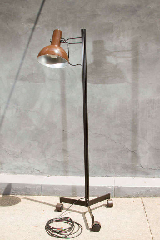 Chocolate brown lacquered metal shades in original condition on a wheeled tripod base. Exposed wire. Unusual 1970s design. 

Available as a pair or individually. 