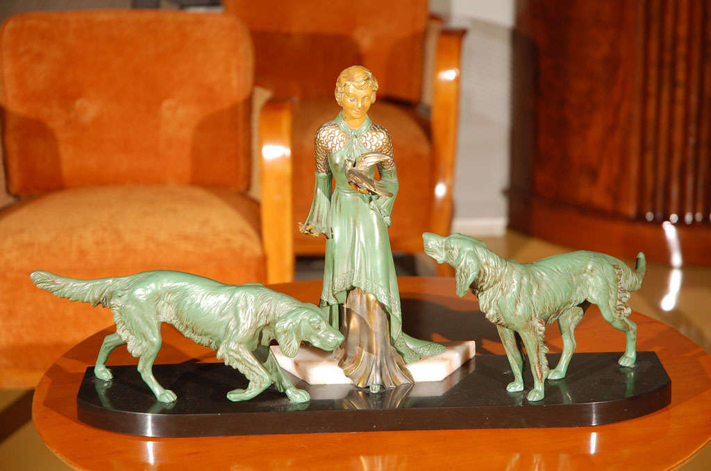 Art Deco statue, green patina on bronze, woman with two dogs on marble base.