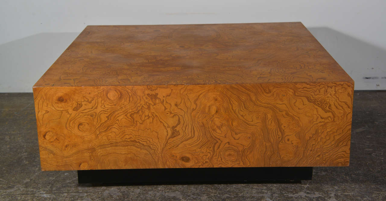 Beautiful burl wood coffee table by Milo Baughman. The burl wood veneer and plinth base gives this piece style. Designed by Milo Baughman