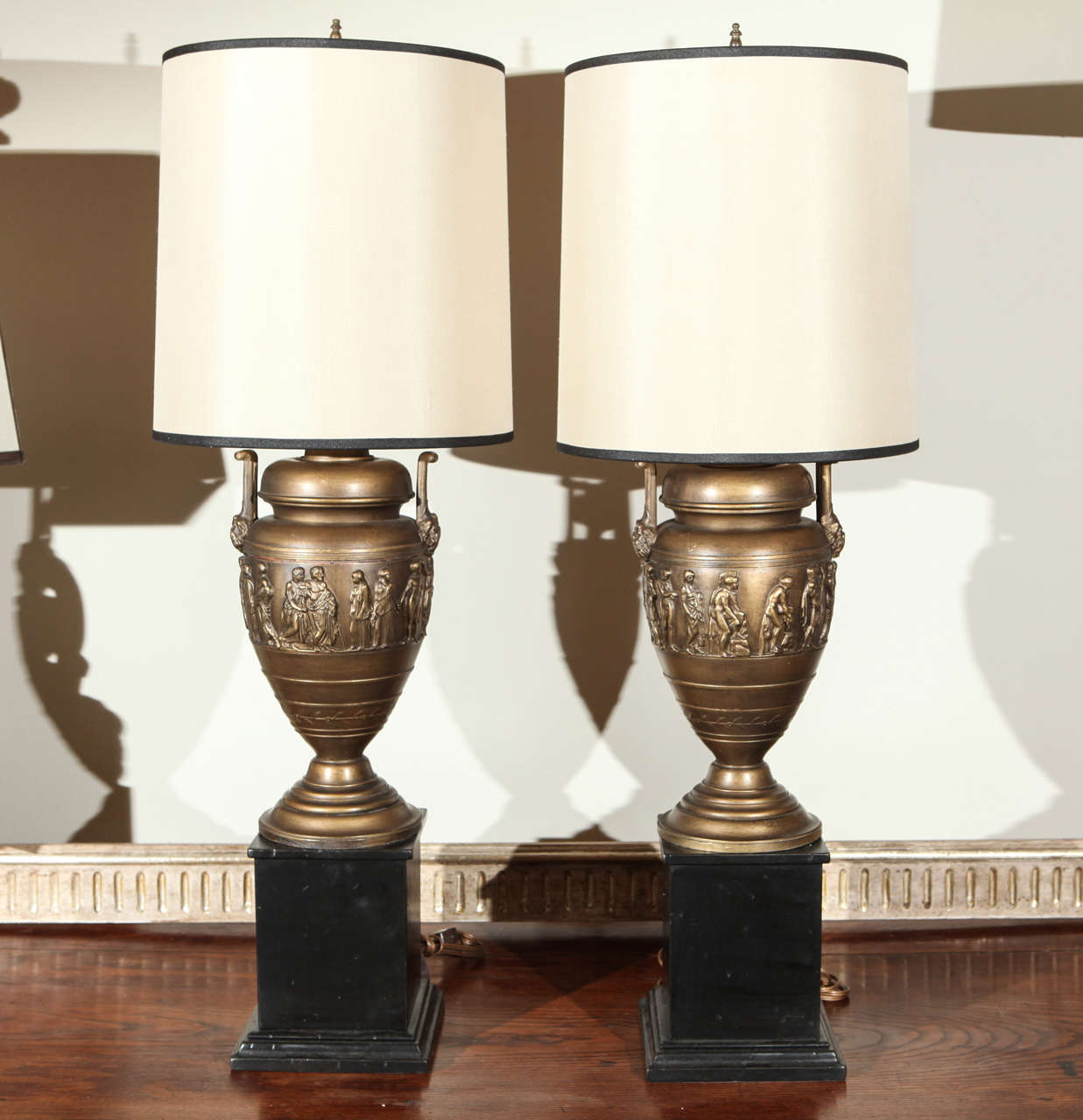 Pair of neo-classic urns on wood bases .
Silk pongee drum shades.