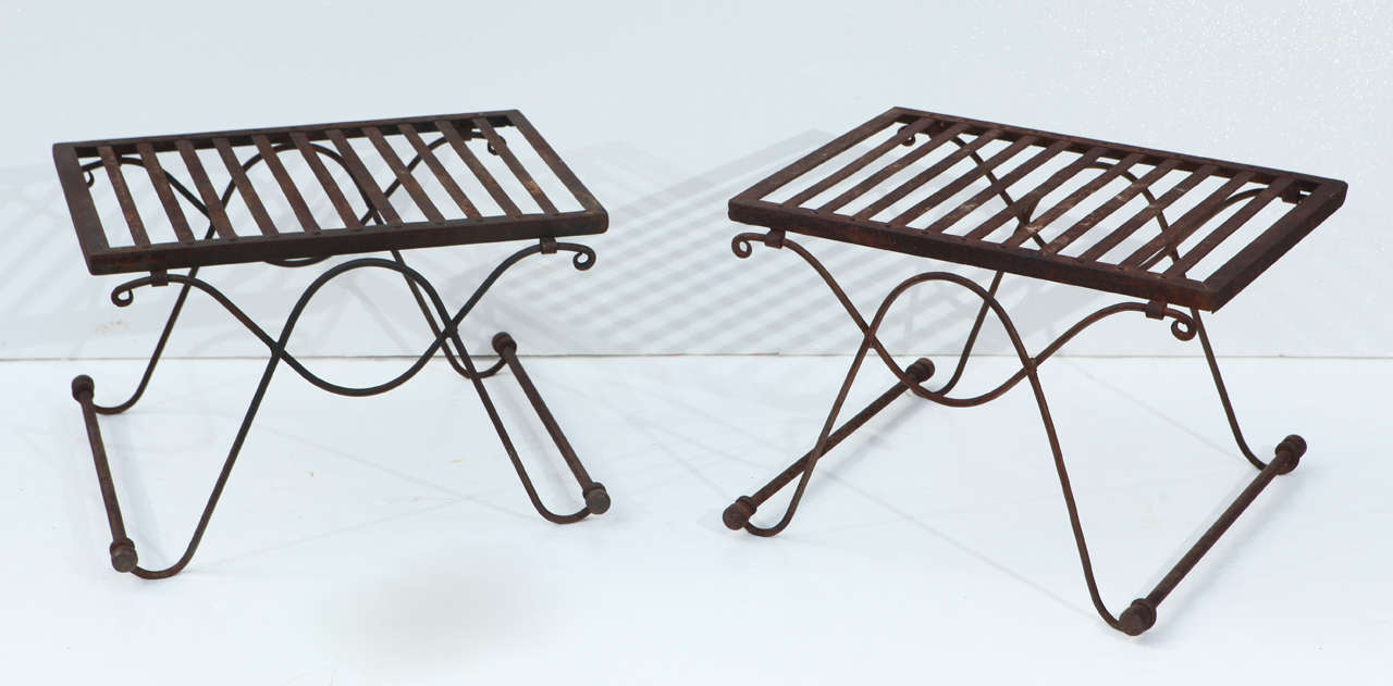 Pair of mid-century wrought iron benches.  Hand riveted tops and handwrought curving sides with iron rods at base, and iron finials.  Very strong pieces.  Ready for your new cushions.
Previously priced at $800.00 for the pair now sale priced at