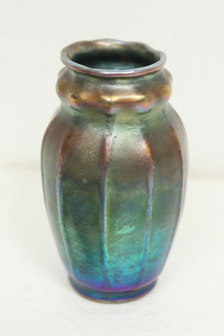 Petite Tiffany Studios New York  vase of iridescent blue glass with ribbed decoration. Handmade, (fabrili) in the Tiffany Studios in the mid-1890s. Signed on the bottom 
L. C.Tiffany, Favrile, 1100.  5986, 1.  Very small chips to the center bottom