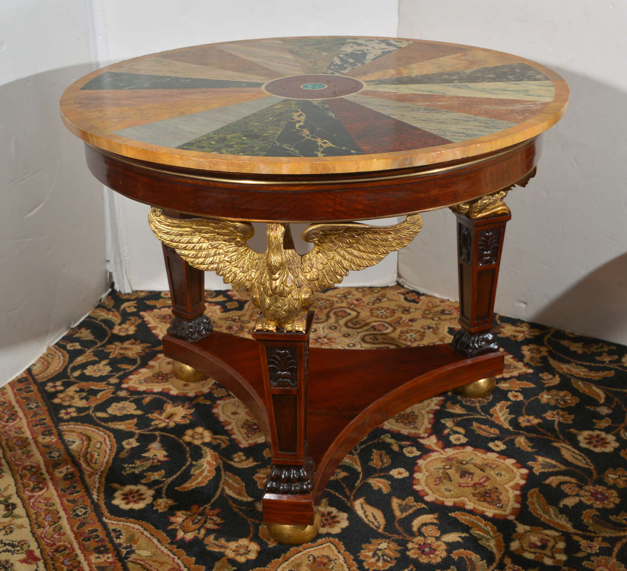 19th c Empire mahogany center table with a marble specimen top and gilded Eagles