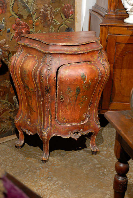Small 19th Century red bombay Venetian commode with single door. Painted and carved. Italian.