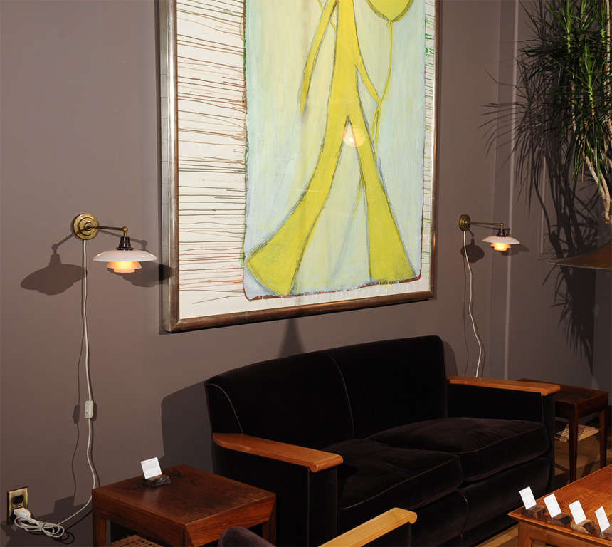 A pair of brass and glass wall sconces by Poul Henningsen with the original glass.