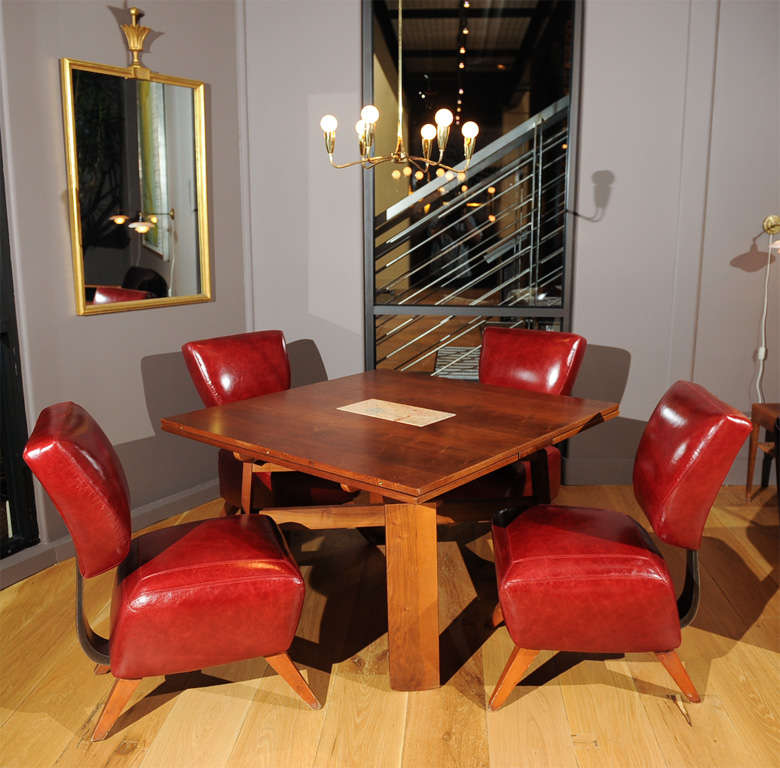 Extension dining table by Silvio Coppola for Bernini made of walnut with a marble hot-plate center piece. The table extends with two hidden leafs to 82 inches.
