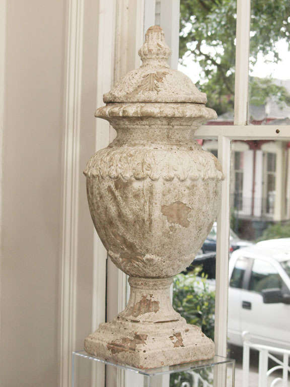 Beautiful pair of terra cotta urns. Off white in color with crackled gesso overlay.  Fine details in molding designs enhance these elegant, decorative urns.
