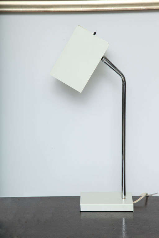Cube white desk lamp with chrome stem by Robert Sonneman, USA, circa 1970. Adjustable, pivoting shade with on/off switch. Newly rewired for USA with French black silk twist cord; takes one standard bulb, 60 watts max. 

Dimensions:
Overall: 20
